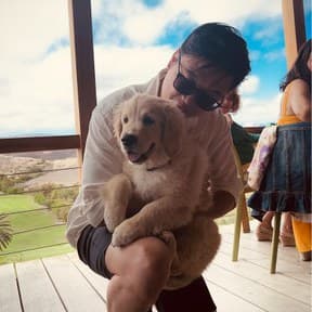 Chris holding a golden retriever puppy